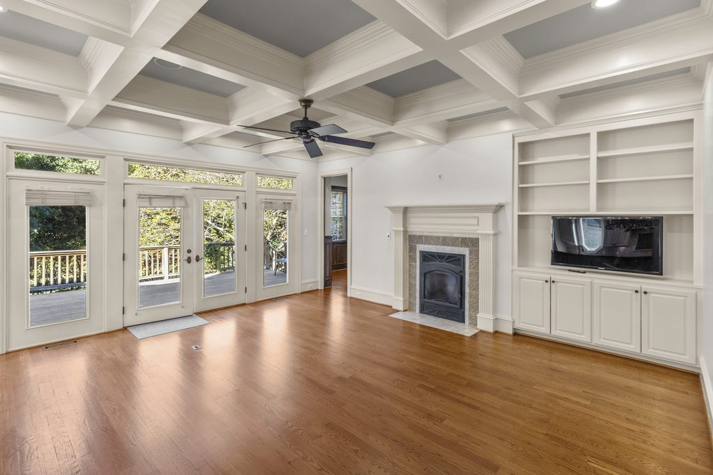 Family room with coffered ceiling and French doors to the deck in a Raleigh, NC home